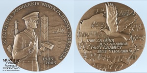 1. Nazwa własna: medal pamiątkowy z okazji 60-lecia Wojsk Ochrony Pogranicza
2. Charakterystyka przedmiotu: medal brązowy o średnicy 7 cm. Awers – sylwetka żołnierza WOP, w tle słup graniczny, w otoku napis: „60  Rocznica Powołania Wojsk Ochrony Pogranicza 1945 – 2005”. Rewers – zarys mapy Polski, nuty na pięcioliniach, lecący orzeł oraz napis: „Tam Za Górą Jest Granica Przy Granicy Jest Strażnica...”.
3. Czas powstania: 2005 r.
4. Hasła przedmiotowe: Wojska Ochrony Pogranicza, przedmioty pamiątkowe
5. Miejsce przechowywania/ właściciel: Sala Tradycji Ośrodka Szkoleń Specjalistycznych SG w Lubaniu